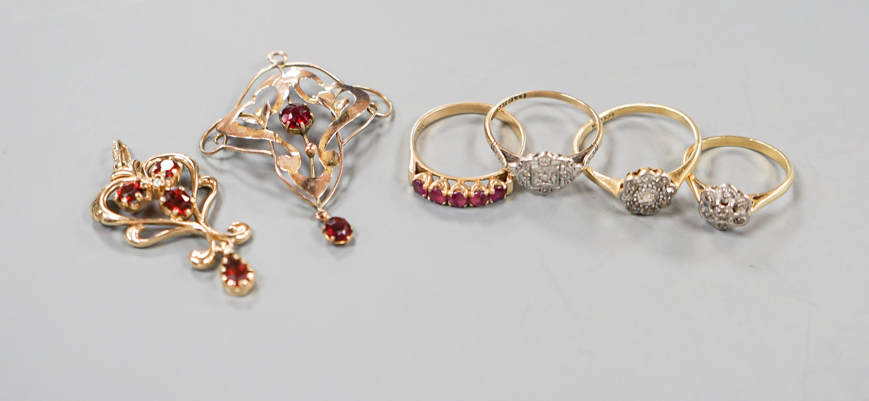 Two 18ct and diamond cluster rings, gross 5.3 grams, a 585 and diamond chip ring, gross 1.7 grams, a 9ct gold gem set ring and two 9ct pendants, gross 8.9 grams.